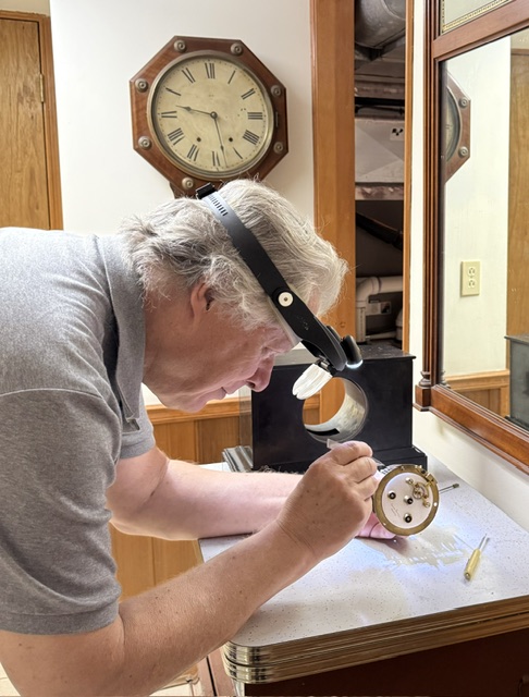 Robert completing clock repair